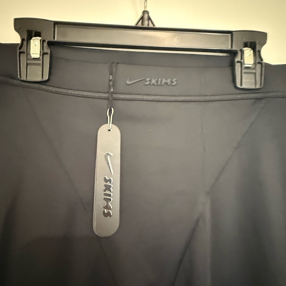 SKIMS Black Leggings. 

NikeSKIMS SHINE V-LINE 26" LEGGING | OBSIDIAN